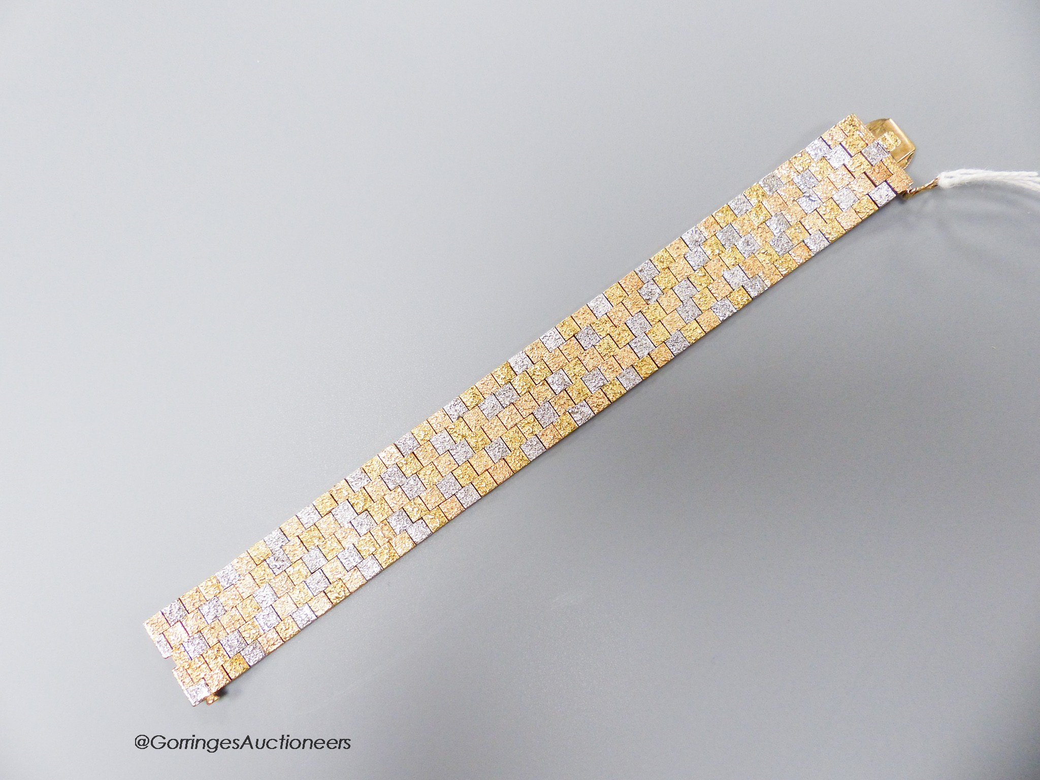 A three-colour 9ct yellow and white gold mesh bracelet, 17.7cm, 51.1 grams.